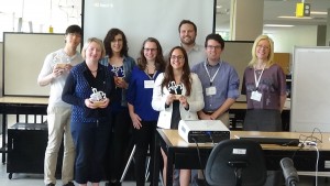 The winners, GeoOne, being presented their trophies by the Summer Institute's faculty.